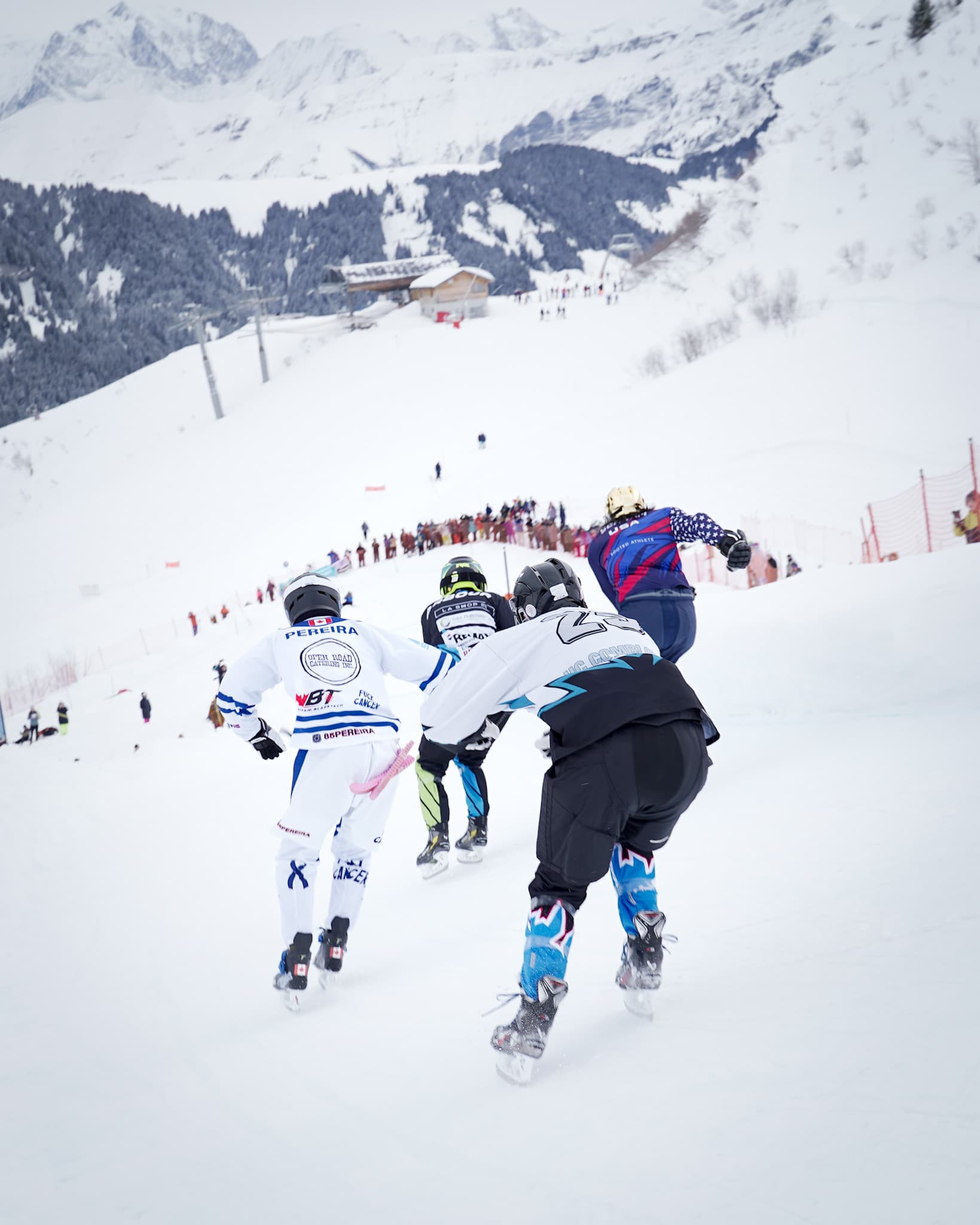 A rider crouching into a turn on the ice track, the Mont-Blanc valley far below